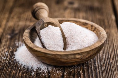 Himalayan Salt on wooden background (selective focus) clipart