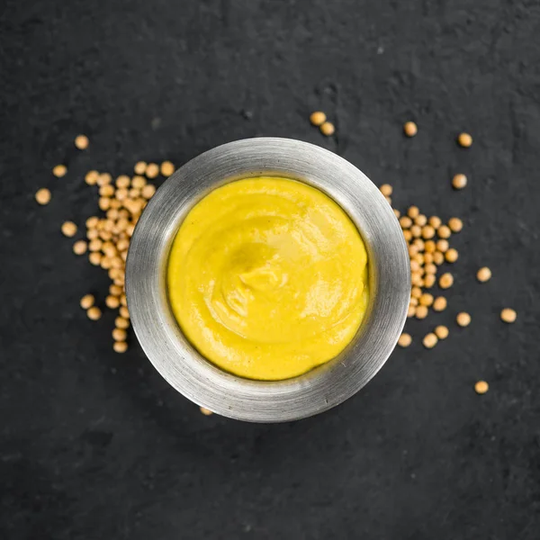 Mustard on a slate slab (selective focus) — Stock Photo, Image
