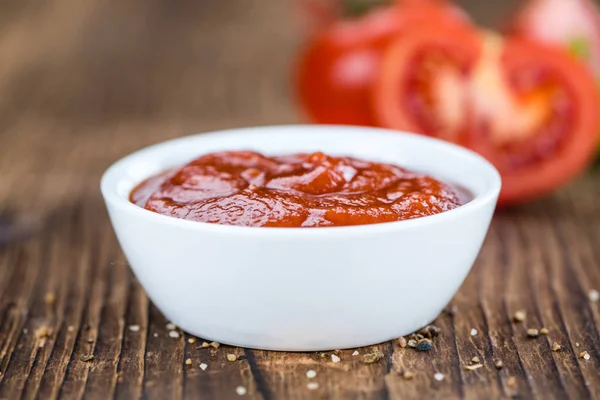 Ketchup de tomate (enfoque selectivo) sobre fondo de madera vintage — Foto de Stock