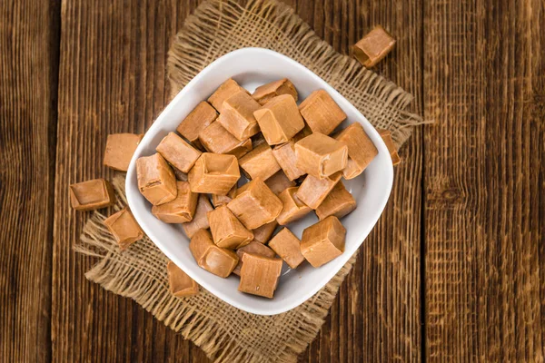 Caramel candies in bowl — Stock Photo, Image