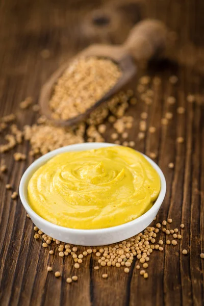 Mustard on wooden background — Stock Photo, Image
