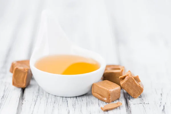 Caramel Syrup with candies — Stock Photo, Image