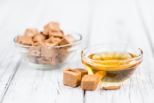 Caramel Syrup with candies — Stock Photo, Image