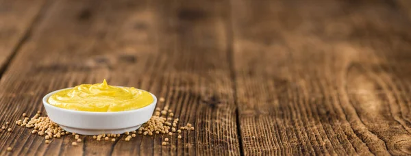 Mustard  on  wooden table — Stock Photo, Image