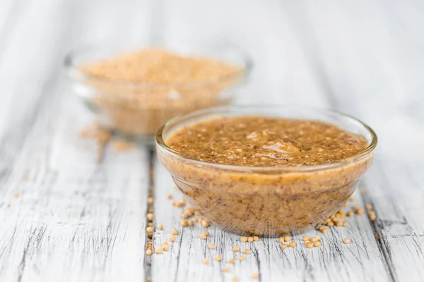 Mustard  on rustic wooden background — Stock Photo, Image