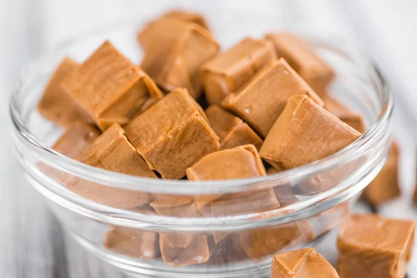 Caramel candies in glass bowl — Stock Photo, Image