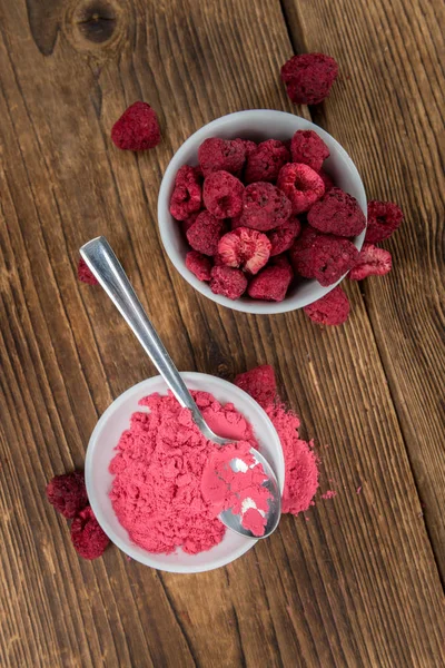 Ground Raspberries on an old wooden table — Stock Photo, Image