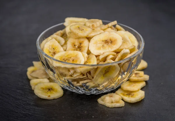 Gedeelte van bananenchips gedroogd op een leisteen plaat — Stockfoto