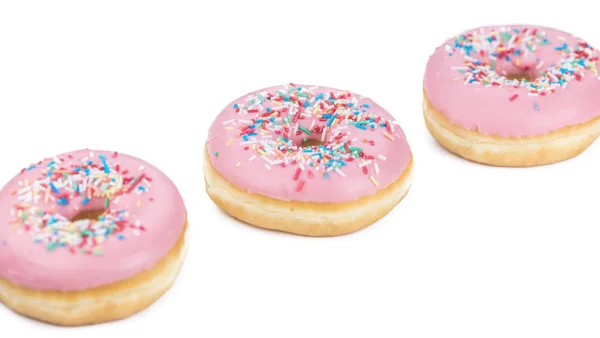 Drei frische rosa Donuts — Stockfoto