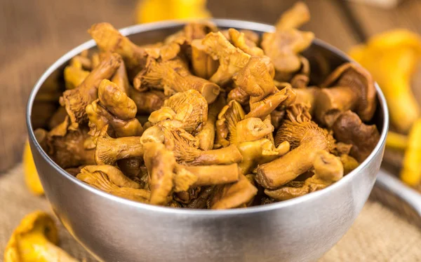 Preserved chanterelles on an old wooden table — Stock Photo, Image