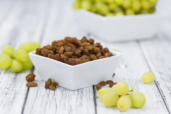 Portion of fresh Raisins on an old wooden table — Stock Photo, Image