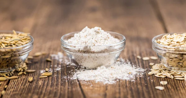 Wooden table with Oat Flour (detailed close-up shot; selective f — Stock Photo, Image