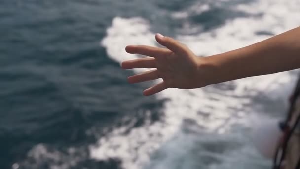 Navio no mar Adriático aberto. A mão dos meninos no ar do navio pega ondas do mar — Vídeo de Stock
