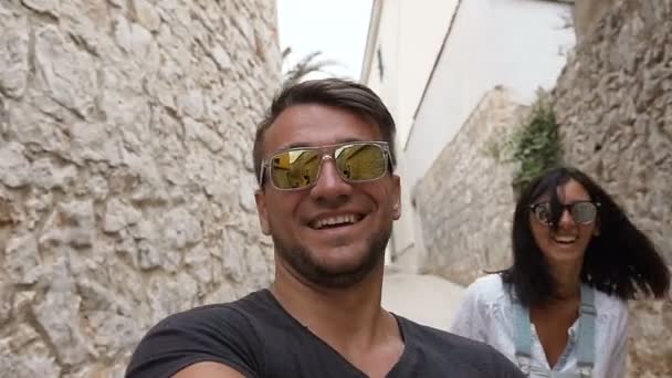 La giovane famiglia felice sta passeggiando per le storiche strade europee della città vecchia. Bella famiglia viaggia in Croazia. I turisti esplorano le attrazioni architettoniche della città . — Video Stock