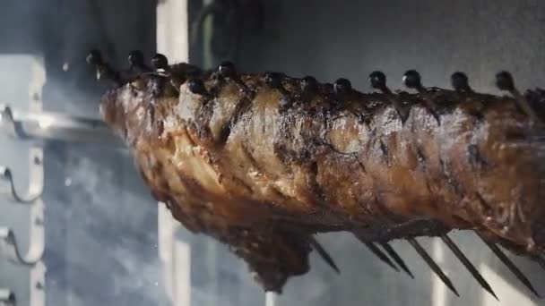 Primer plano La carne de cerdo jugosa se tuesta en un asador, barbacoa, parrilla — Vídeos de Stock