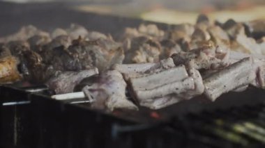 Duman kızarmış etin üzerine kömürlerin üzerinde şiş üzerinde yükselir. Izgara et