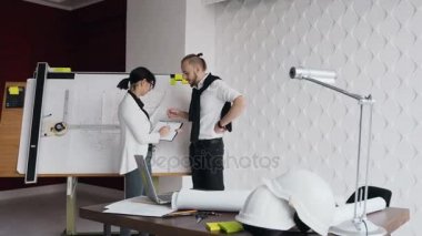 Genç kadını kocası ve mimar mühendis tartışmak plan proje tasvir çizim tablo yakınındaki yeni bir ev inşa için