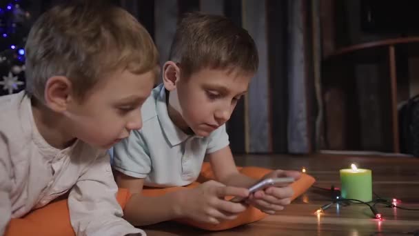 Little boys found in telephone interesting game and they is very fascinated by it — Stock Video