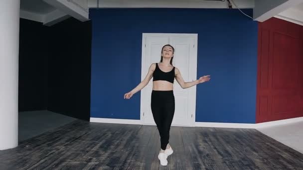 Giovane bella ragazza caucasica che pratica la danza nella sala, sullo sfondo muro rosso e blu. Fitness ragazza, allenamento, allenamento — Video Stock