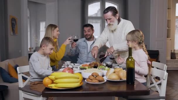 Långsam rörelse av trevliga glada leende människor under festlig familjemiddag på Thanksgiving dag — Stockvideo