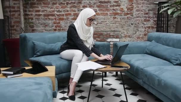 Une jeune femme d'affaires indépendante asiatique prospère utilise un ordinateur portable et travaille avec des documents de travail papier au bureau. Concept d'entreprise et de personne — Video