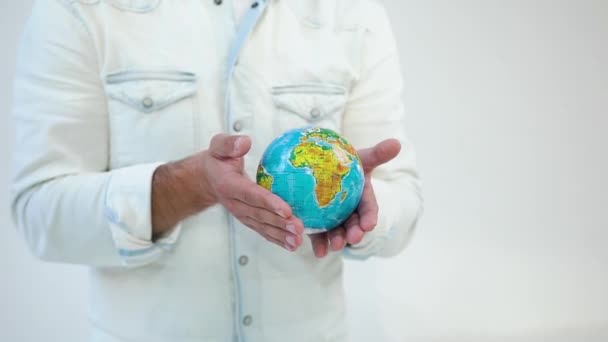 Unknown good-dressed man holding in his hands mockup of earth on the white background — 비디오