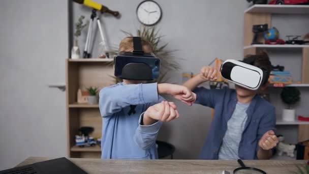 Attractive portrait of two teen boys which enjoying video game using virtual reality headset — 비디오