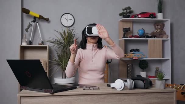 Attractive portrait of good-looking modern young woman which using augmented reality glasses touching imaginary screen in air — Stock Video