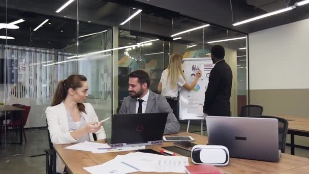 Attractive portrait of satisfied high-skilled 30-35s multiethnic business people which working together in meeting room under business project — Stok video