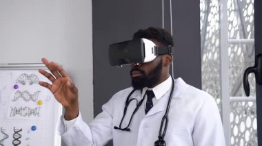 Portrait of Afro american scientist using and testing virtual reality glasses while working in hospital office room. Dolly shot