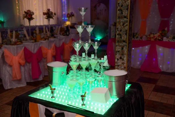 A pyramid of champagne glasses at the wedding.