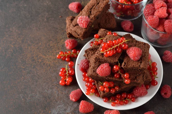 Chocolate brownies with raspberries and currants