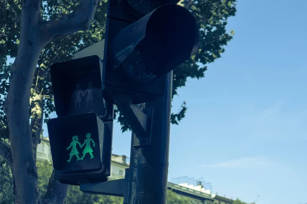 Traffic signal depicting people holding hands in Madrid, Spain,