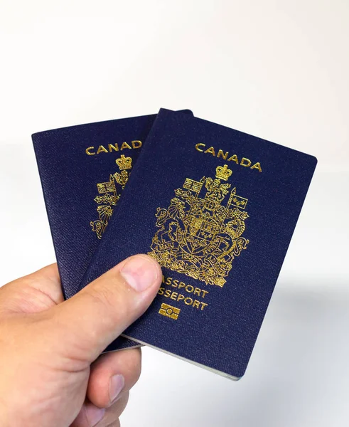 Hand holding two Canadian passports — Stock Photo, Image