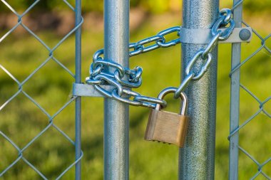 Chain and lock on a chainlink fence clipart