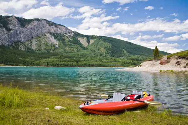 An inflatable kayak on a lake in the mountains