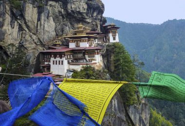 Paro Taktsang with prayer flags - Bhutan clipart