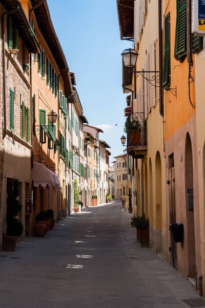Beautiful narrow street with old facades in a tuscany village - Italy