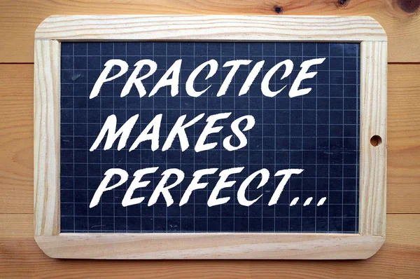 Practice Makes Perfect written on a Blackboard