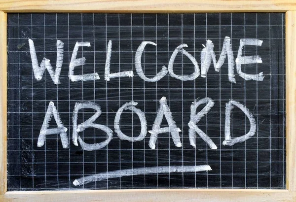 The words Welcome Aboard written by hand on a blackboard