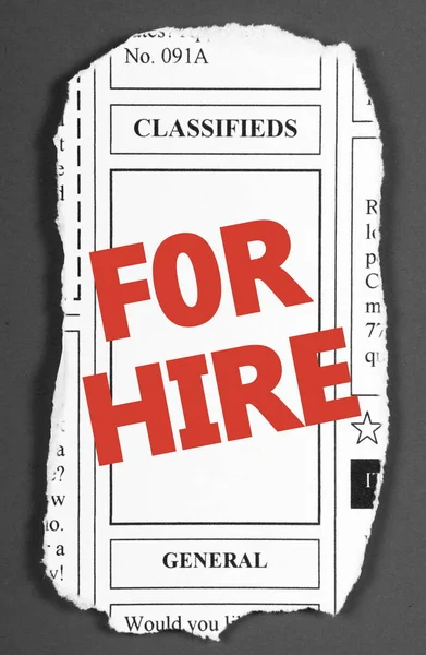 The words FOR HIRE in red text on a clipping from the classified advertising section of a newspaper — Stock Photo, Image