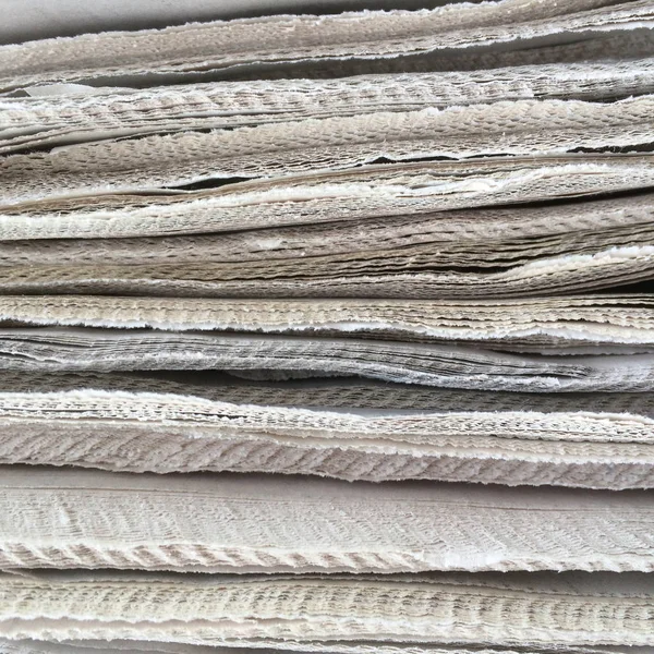 Close up of the edges of a stack of newspapers — Stock Photo, Image