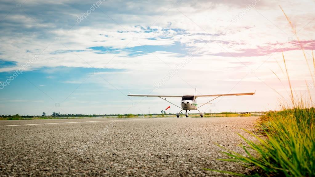 Small airplane coming  on a taxiway in the morning with beautiful blue sky. Bright life. High growth and high risk business concept.
