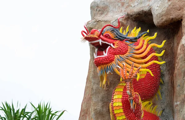 Red dragon statue in stone cave