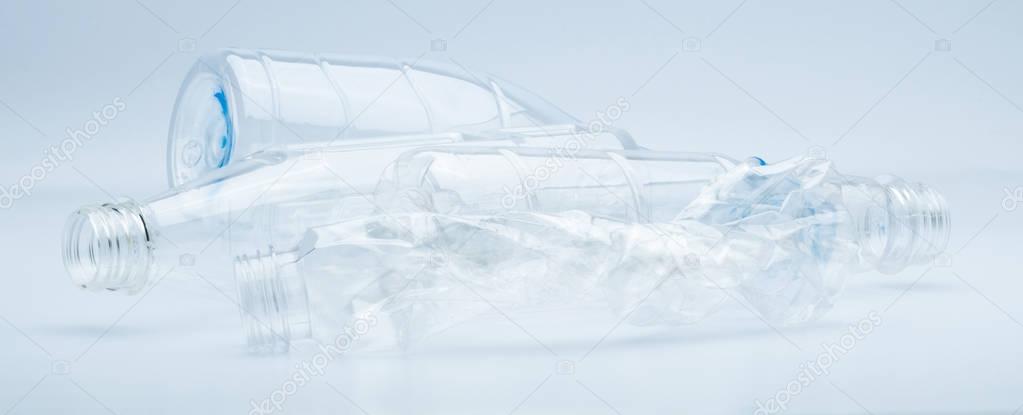 Waste of transparent plastic bottles isolated on white background with copy space