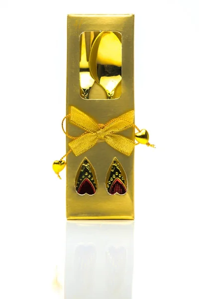 Garfo e colher em talheres caixa de ouro com ornamentos em um fundo branco com espaço de cópia — Fotografia de Stock