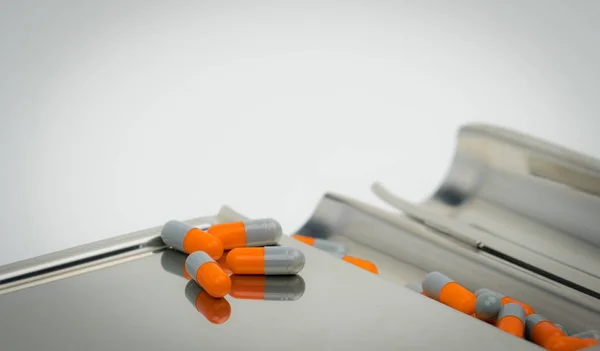 Colorido de píldoras de cápsulas antibióticas con sombras en bandeja de acero inoxidable, concepto de resistencia a los medicamentos . — Foto de Stock