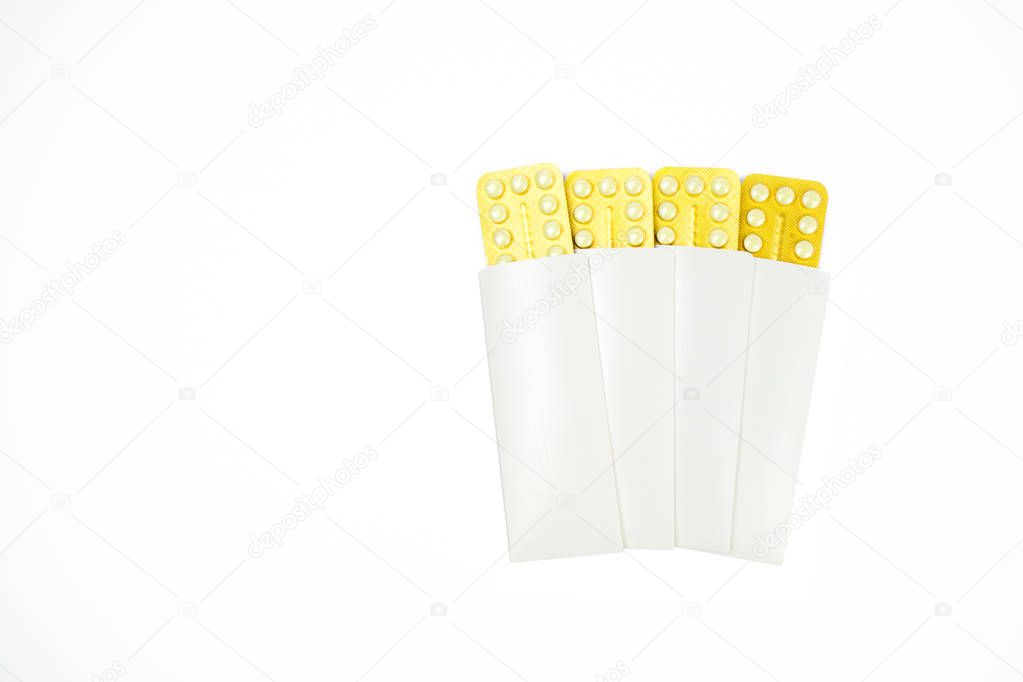 Four blister of contraceptive pills in white envelope isolated on white background with copy space. Family planning concept.