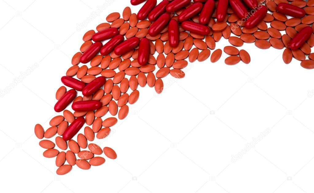 Red vitamins and supplements capsule and iron tablets isolated on white background with copy space and clipping path. Use for topics content about treatment anemia in adult and elderly people