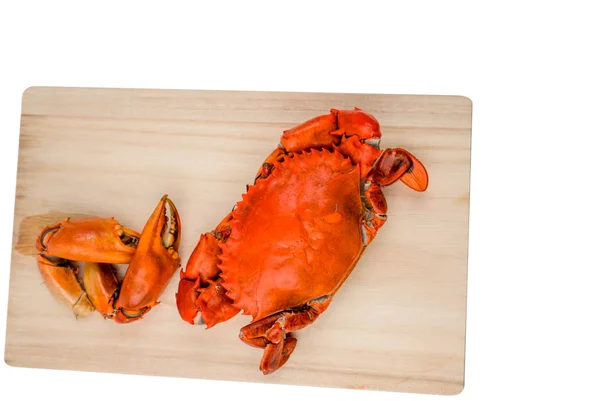 Top view of Scylla serrata. One steamed crab with two big claw separated on wood cutting board isolated on white background with copy space. Seafood restaurants concept. — Stock Photo, Image